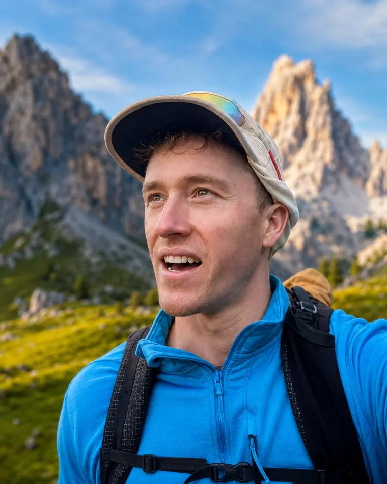 Jack on a mountain trail in the Dolomites, pack on, limestone peaks behind